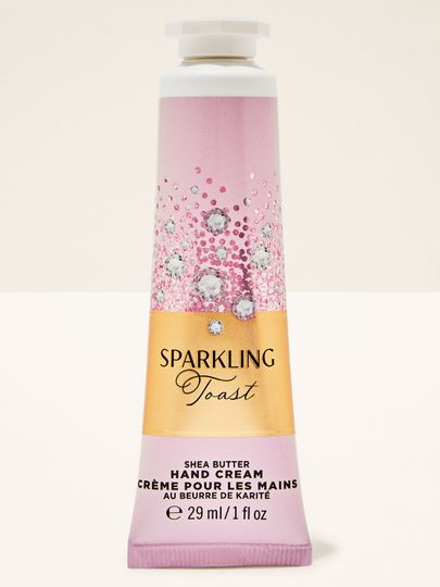 Cremă de mâini Sparkling Toast Bath & Body Works în tub roz‑auriu cu etichetă strălucitoare