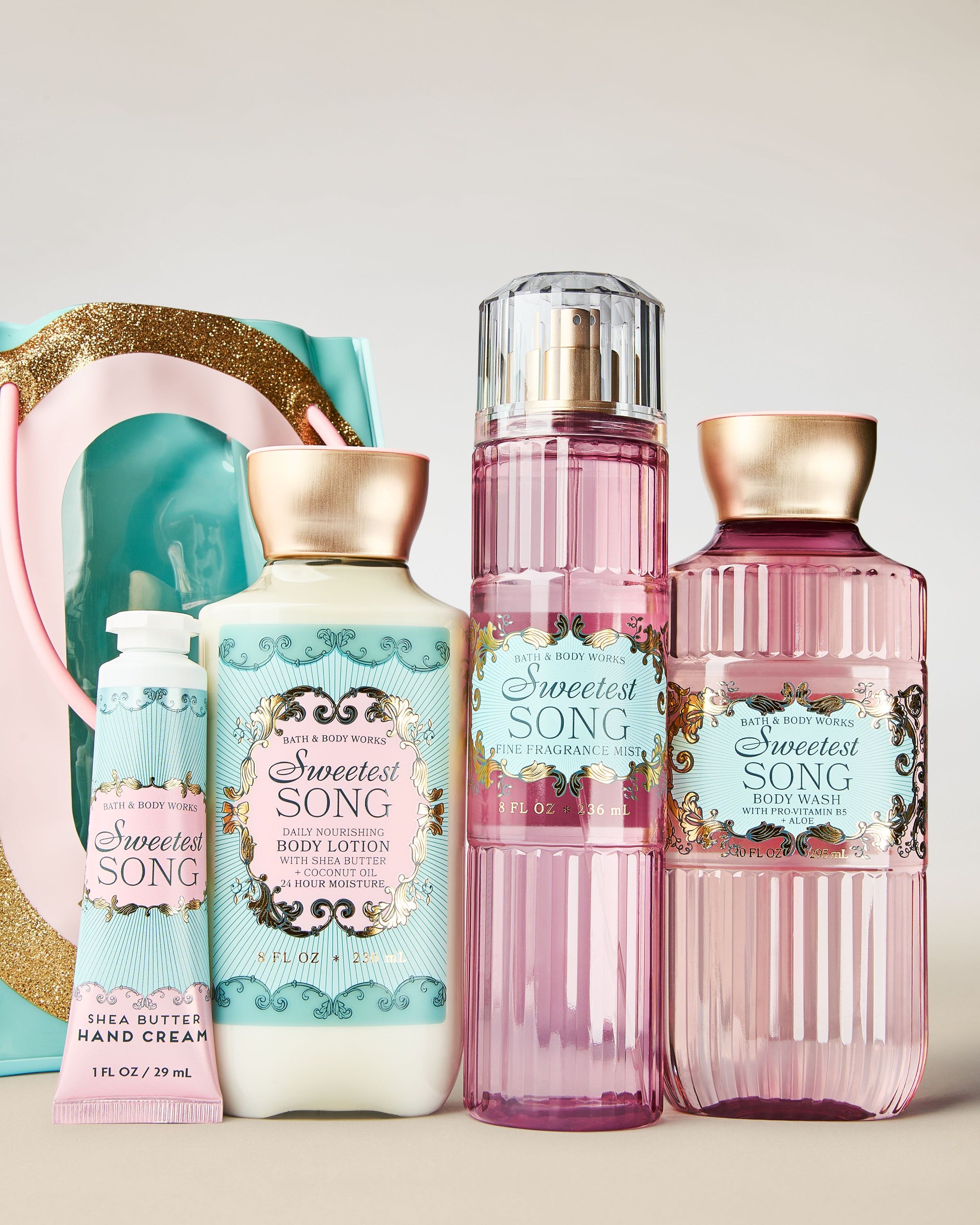 Set cadou Bath & Body Works Sweetest Song cu mist, gel de duș, loțiune și cremă de mâini, într-o geantă decorativă.