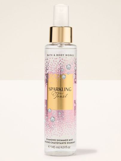 Spray Diamond Shimmer Mist Sparkling Toast Bath & Body Works în sticlă roz‑aurie cu particule strălucitoare