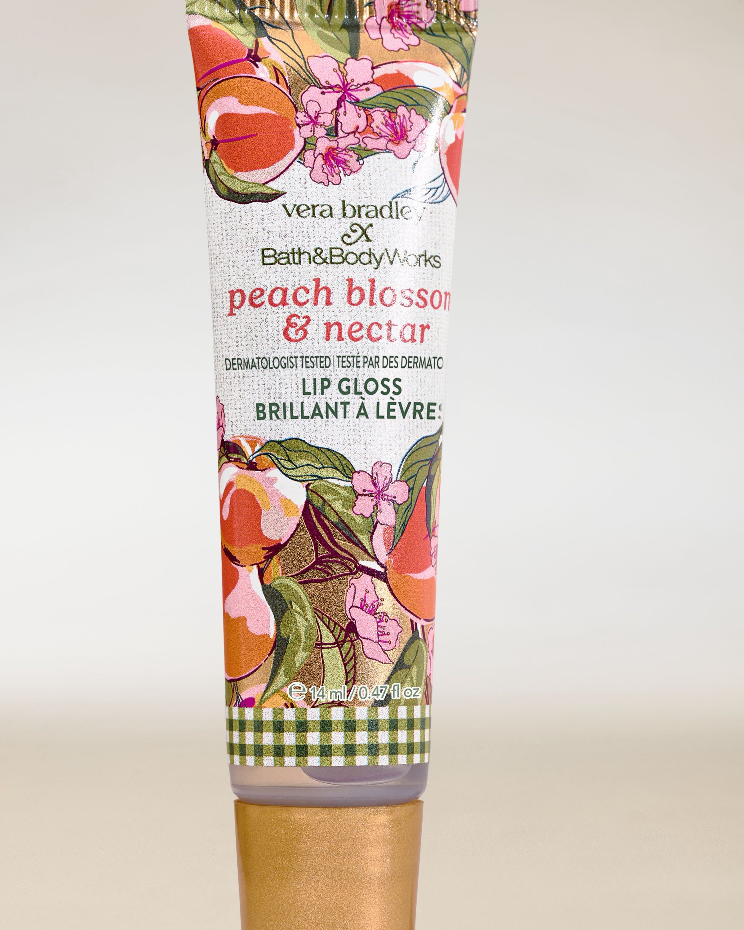 Bath & Body Works Peach Blossom & Nectar – luciu de buze într-un tub cu design floral‑fructat.