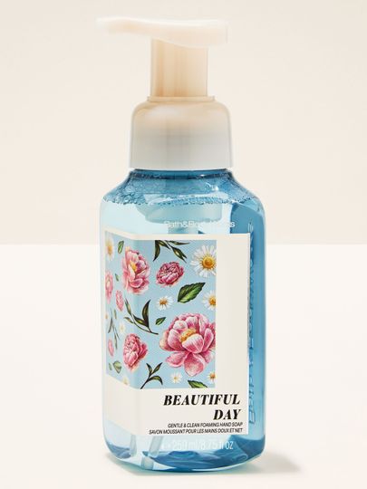 Săpun spumant „Beautiful Day” în flacon albastru cu etichetă florală, pe fundal luminos.