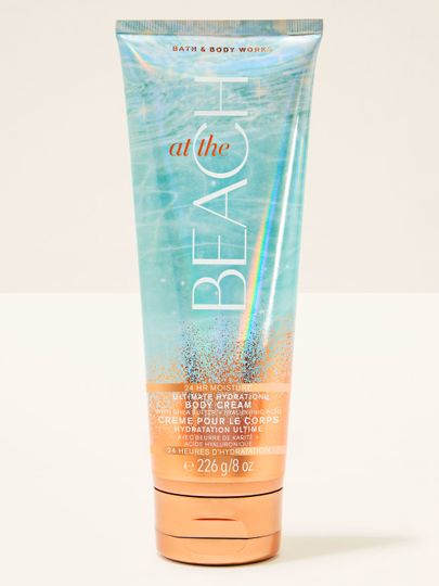 Cremă de corp Bath&Body Works At the Beach. Tub turcoaz-portocaliu, cu sclipici și inscripții.