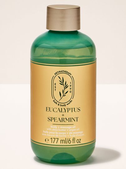 Ulei de masaj Bath & Body Works "Eucalyptus + Spearmint" cu unt de shea și ulei de argan, în sticlă verde.