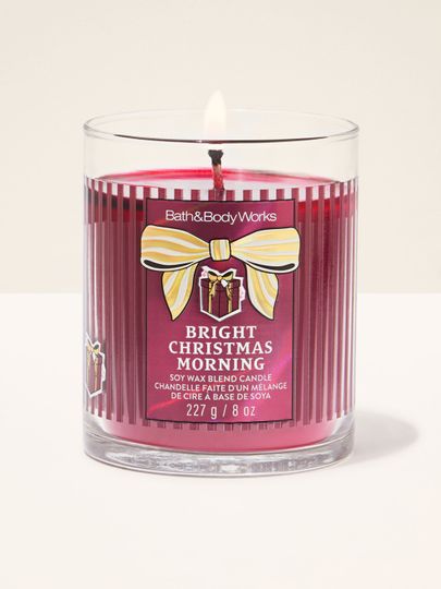 Lumânare parfumată Bright Christmas Morning Bath & Body Works cu un fitil aprins și motiv de cadou