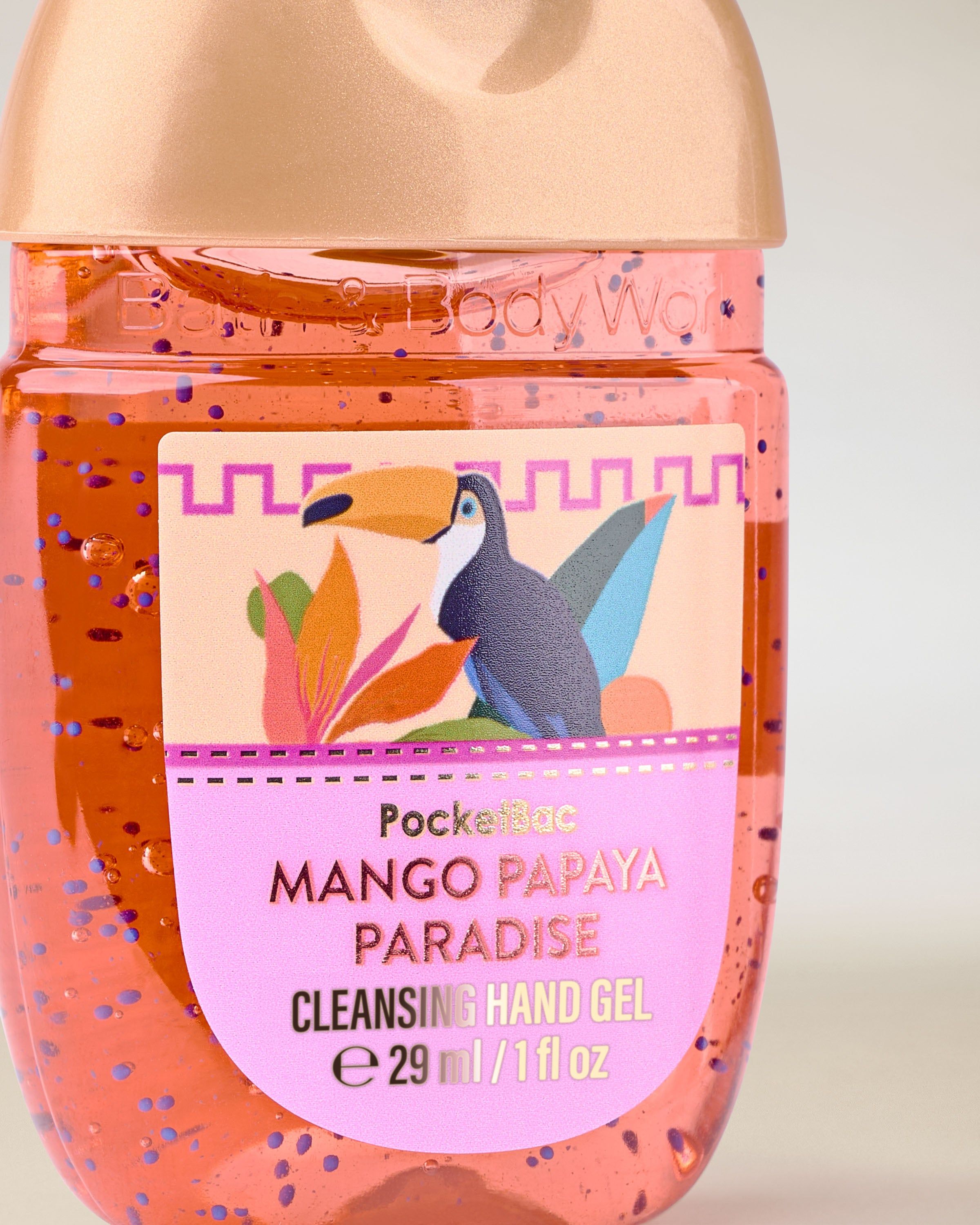 PocketBac Mango Papaya Paradise – gel de mâini în recipient portocaliu cu capac auriu și etichetă tropicală.
