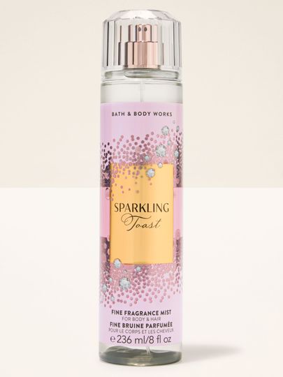 Spray de corp Sparkling Toast Bath & Body Works în sticlă roz cu etichetă aurie strălucitoare