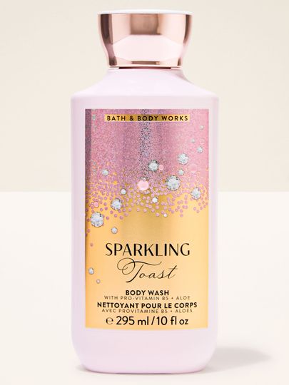 Gelul de duș roz Sparkling Toast Bath & Body Works în sticlă cu etichetă roz‑aurie