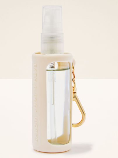 Suport pentru mini spray Bath & Body Works, cu carcasă crem și carabină aurie.