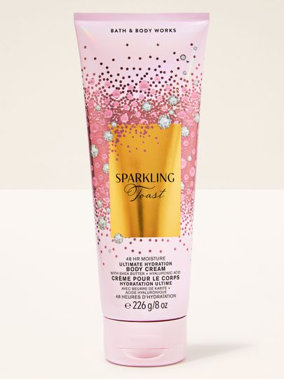 Cremă de corp Sparkling Toast Bath & Body Works în tub roz cu etichetă aurie strălucitoare