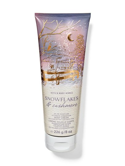 Vánoční tělový krém v tubě s motivem zimní vesničky, zdobený sněhovými vločkami a nápisem "Magic in the air", Bath & Body Works.