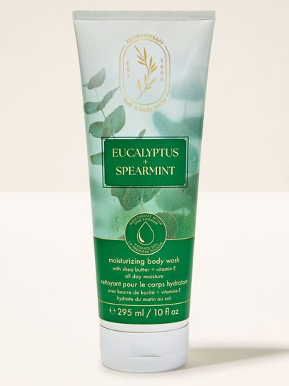 Gel de duș cremos Bath & Body Works "Eucalyptus + Spearmint" în tub cu grafică de frunze de eucalipt.