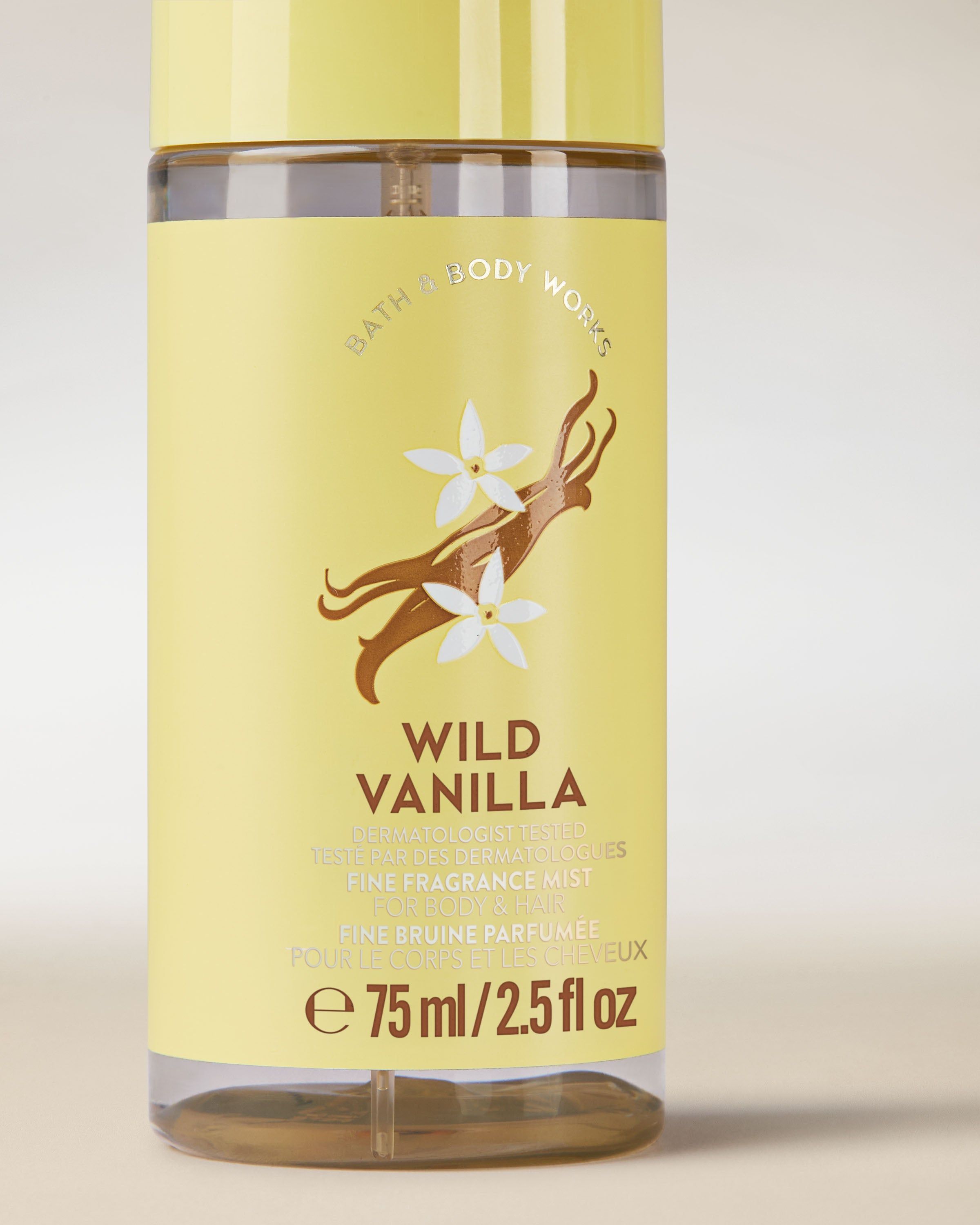 Ceață parfumată pentru corp și păr Wild Vanilla într‑o sticlă galbenă