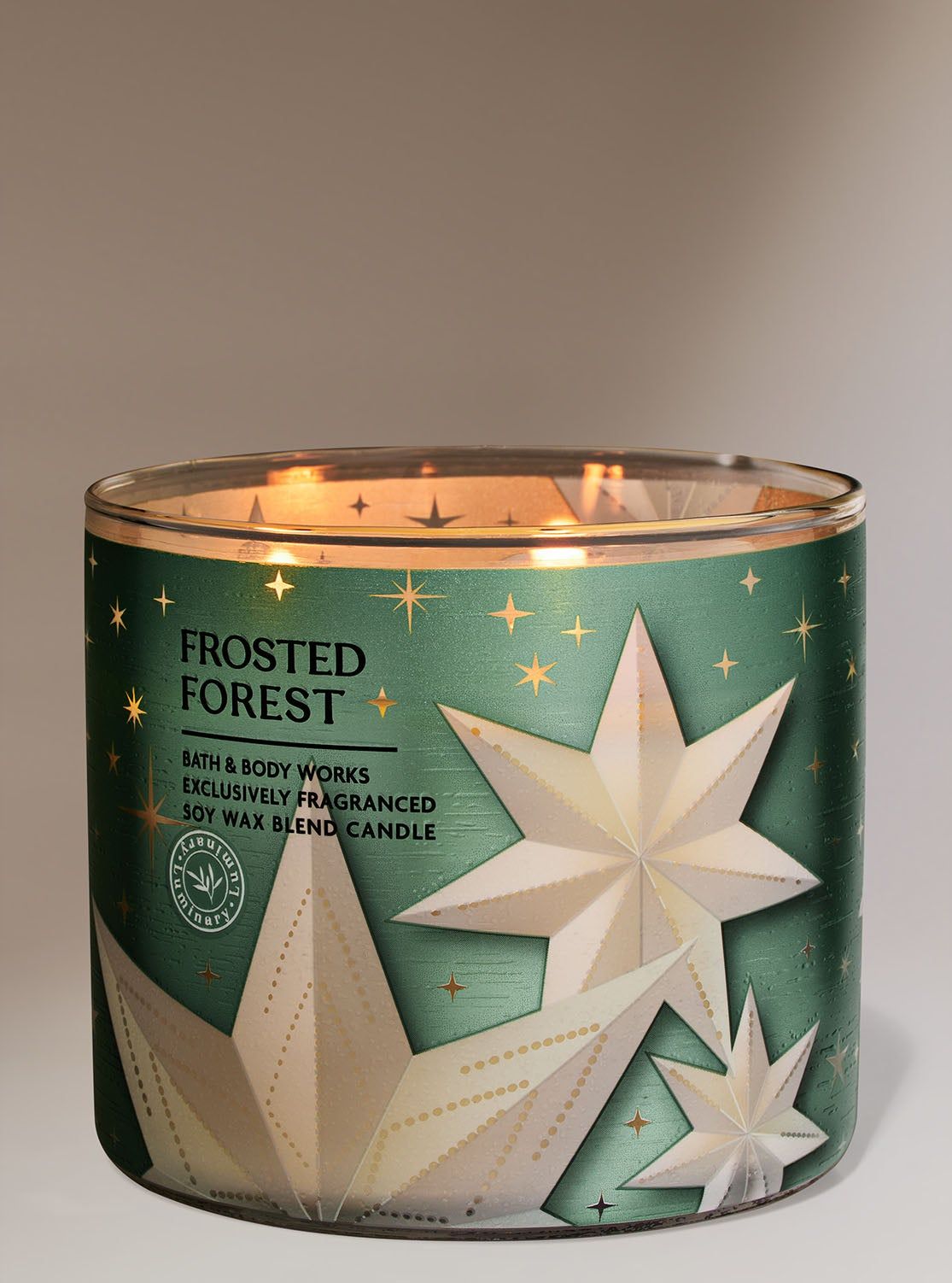 Svíčka „Frosted Forest“ ve skleněné nádobě se světle modrou etiketou a trojrozměrnými hvězdami, Bath & Body Works.