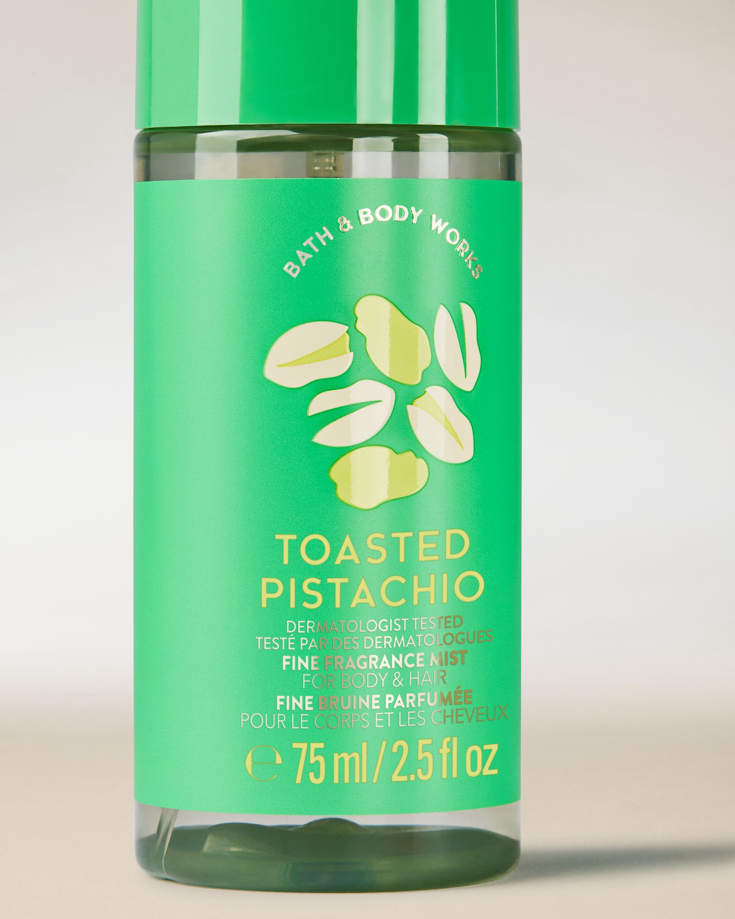 Ceață parfumată pentru corp și păr Toasted Pistachio într‑o sticlă verde