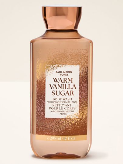 Gel de duș "Warm Vanilla Sugar" în sticlă portocalie cu etichetă sclipitoare Bath & Body Works.