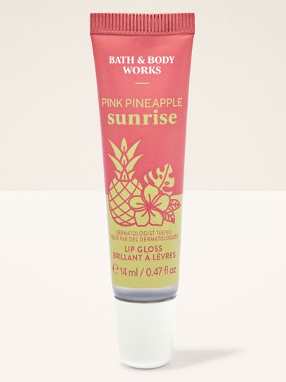 Pink Pineapple Sunrise – błyszczyk do ust w różowym opakowaniu z tropikalną grafiką ananasa i hibiskusa.