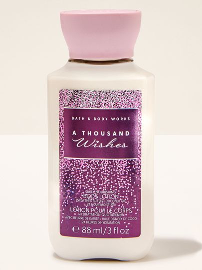 Loțiune mini Bath & Body Works A Thousand Wishes cu etichetă roz‑mov cu efect strălucitor.